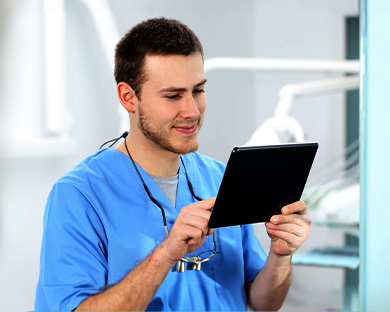 A medical professional working on a tablet