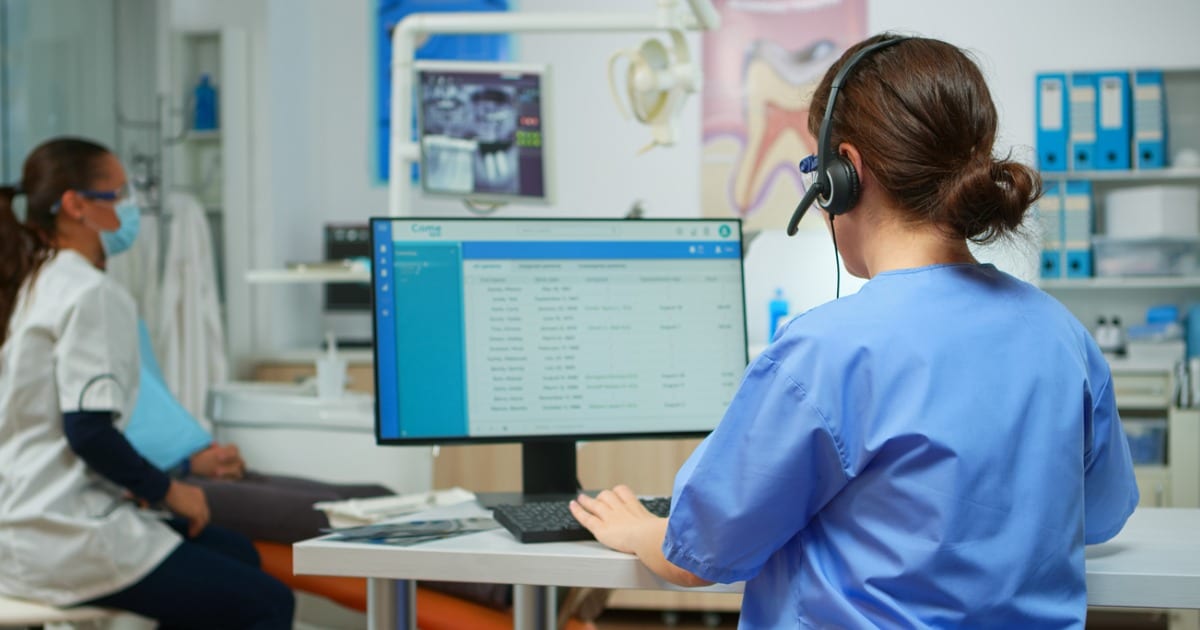 Dental staff working on a computer